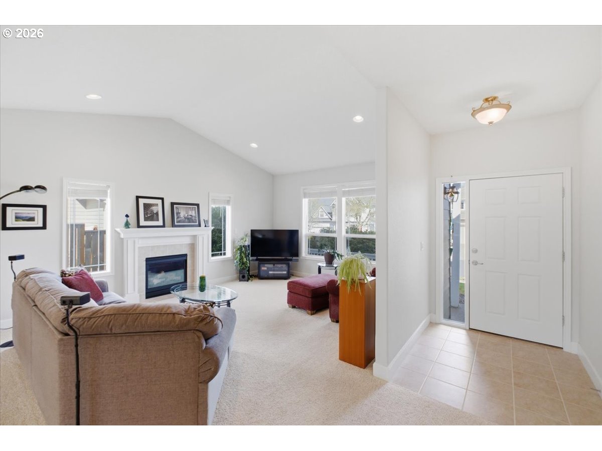 2066 Northwest Violet Avenue Albany, OR 97321 - Photo 7 of 48 a living room with furniture a fireplace and a flat screen tv