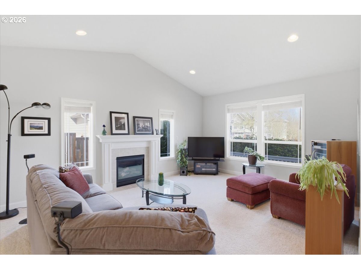 2066 Northwest Violet Avenue Albany, OR 97321 - Photo 8 of 48 a living room with furniture a fireplace and a flat screen tv