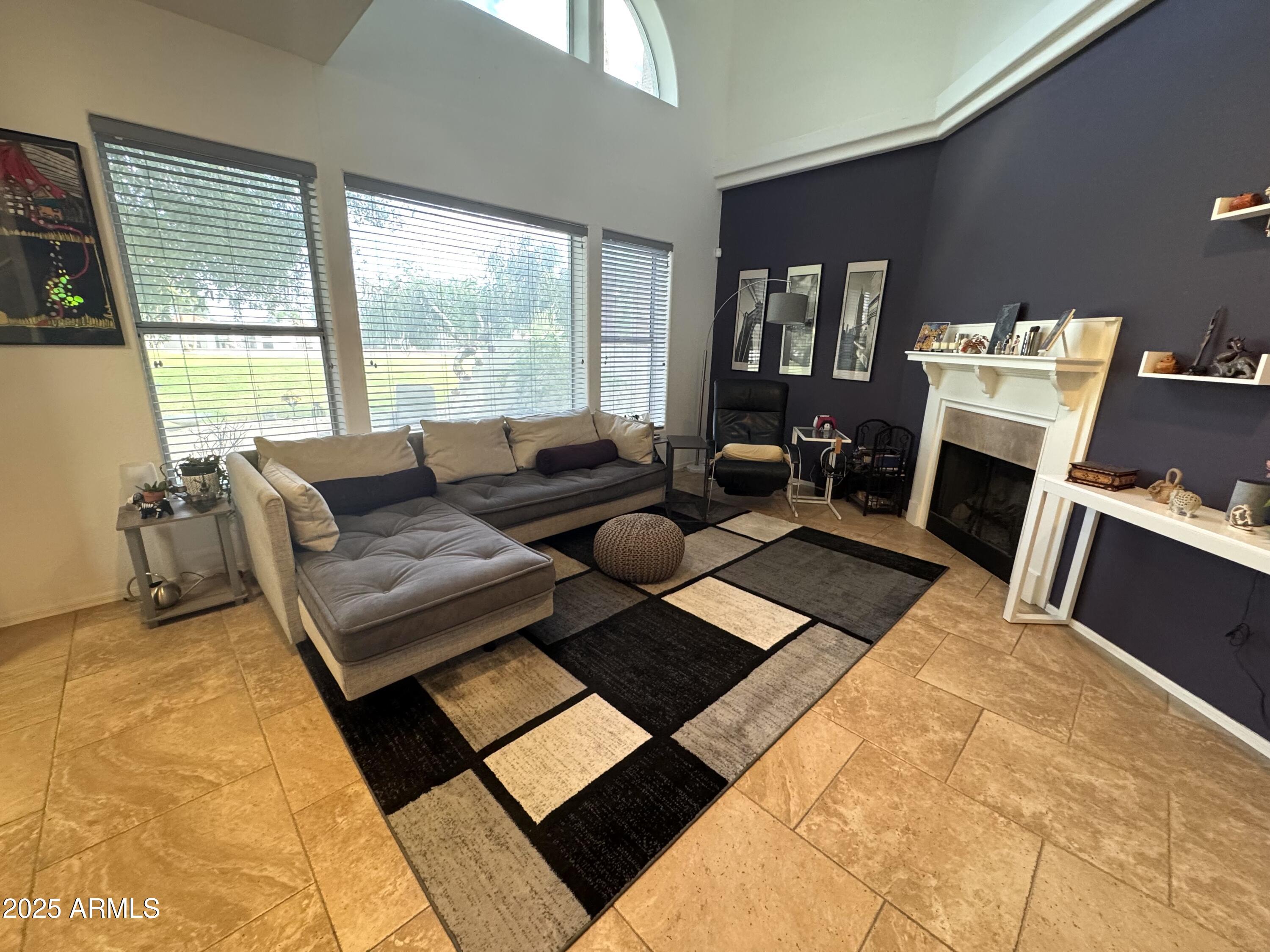 8833 South 51st Street, Unit 3 Phoenix, AZ 85044 - Photo 1 of 26 a living room with furniture and a fireplace