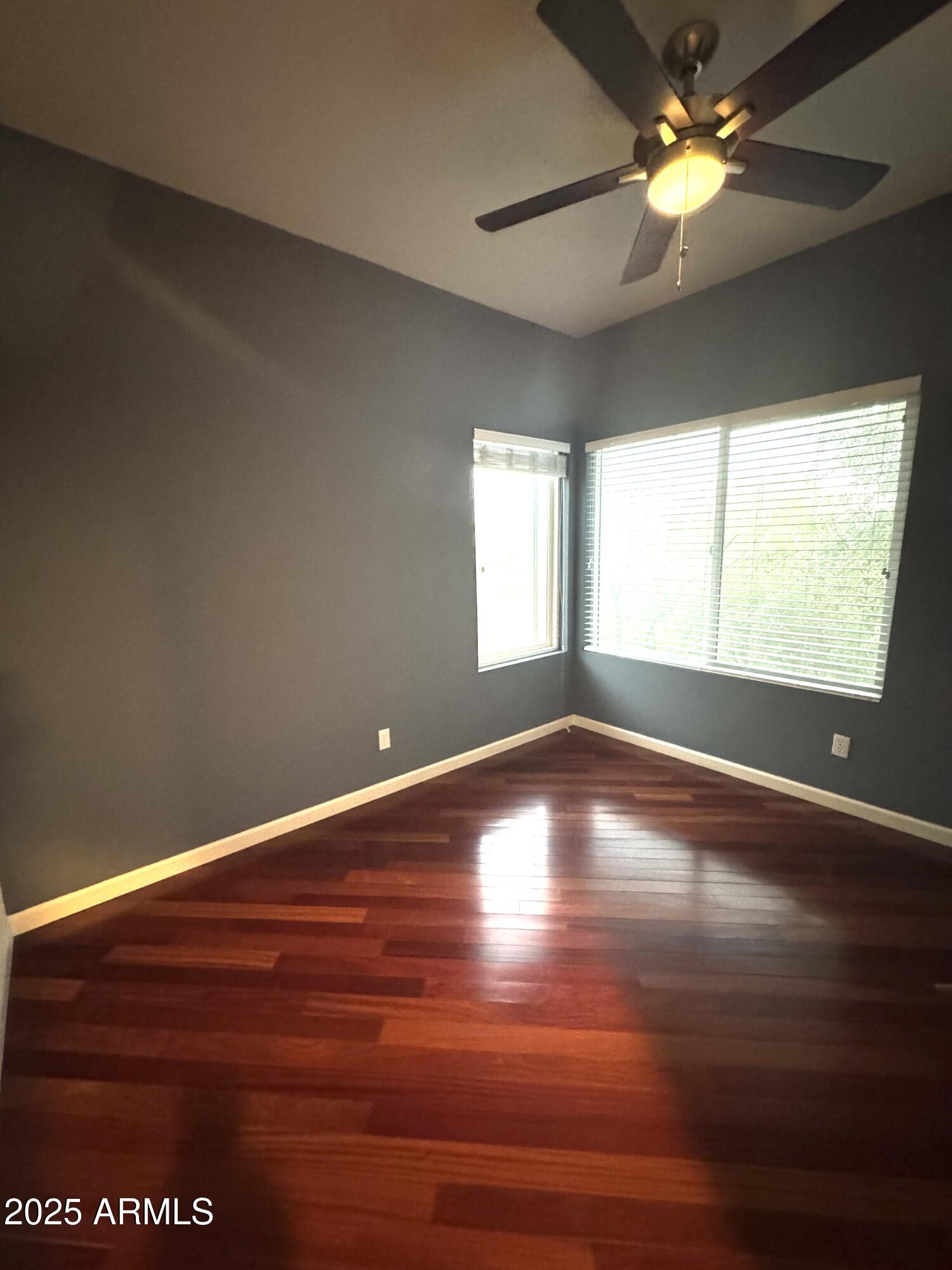 8833 South 51st Street, Unit 3 Phoenix, AZ 85044 - Photo 13 of 26 a view of an empty room with window and wooden floor