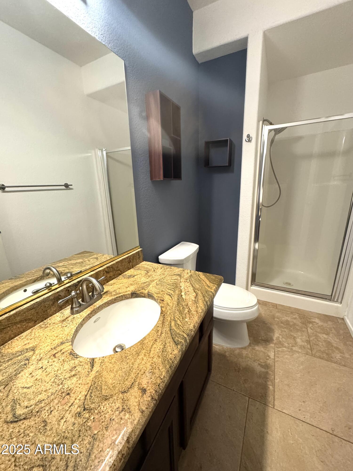 8833 South 51st Street, Unit 3 Phoenix, AZ 85044 - Photo 14 of 26 a bathroom with a granite countertop sink and a mirror