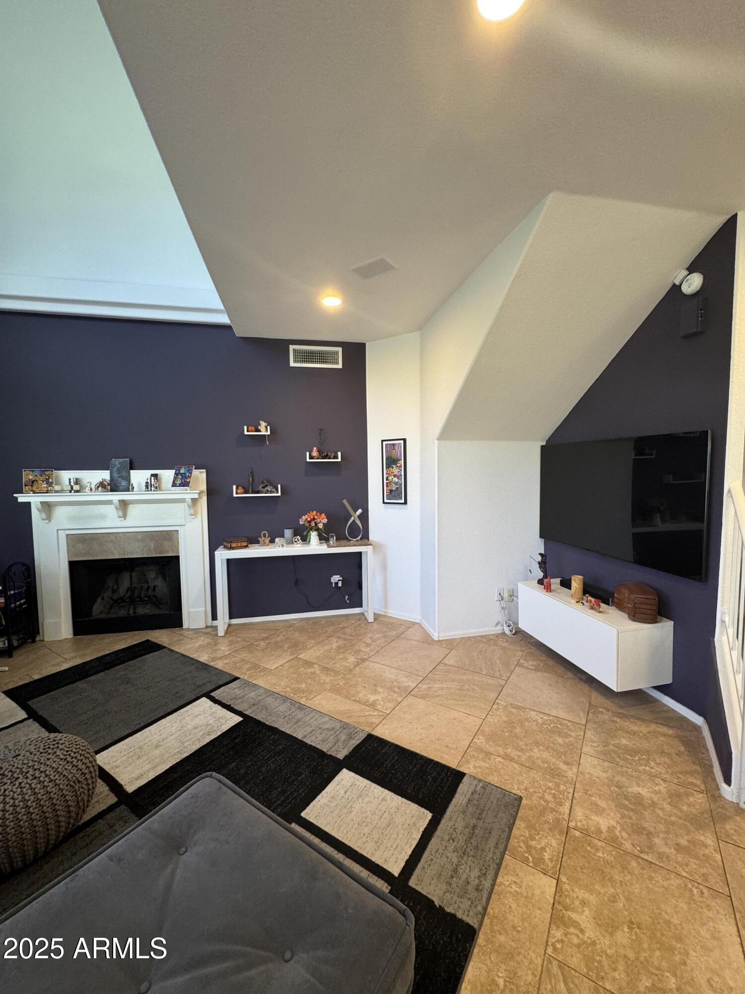 8833 South 51st Street, Unit 3 Phoenix, AZ 85044 - Photo 3 of 26 a living room with furniture and a fireplace