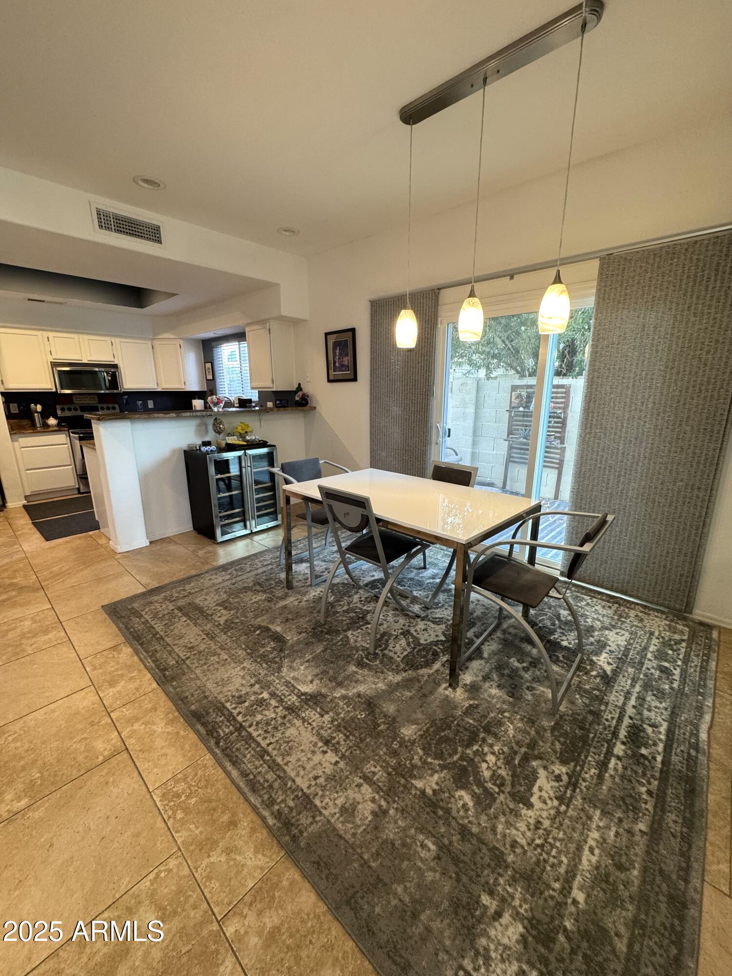 8833 South 51st Street, Unit 3 Phoenix, AZ 85044 - Photo 7 of 26 a room with furniture and view of kitchen