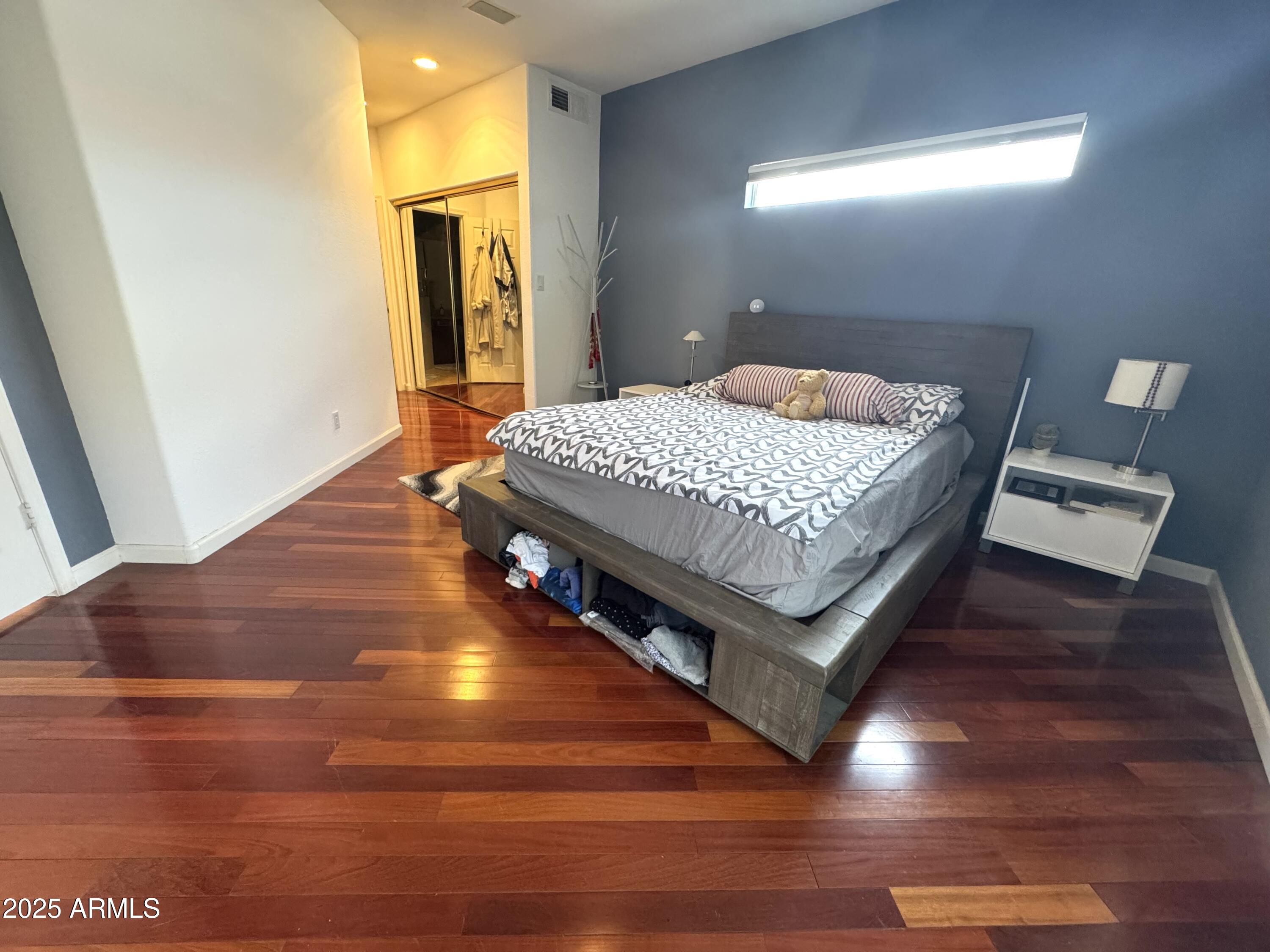 8833 South 51st Street, Unit 3 Phoenix, AZ 85044 - Photo 8 of 26 a bedroom with a bed and wooden floor