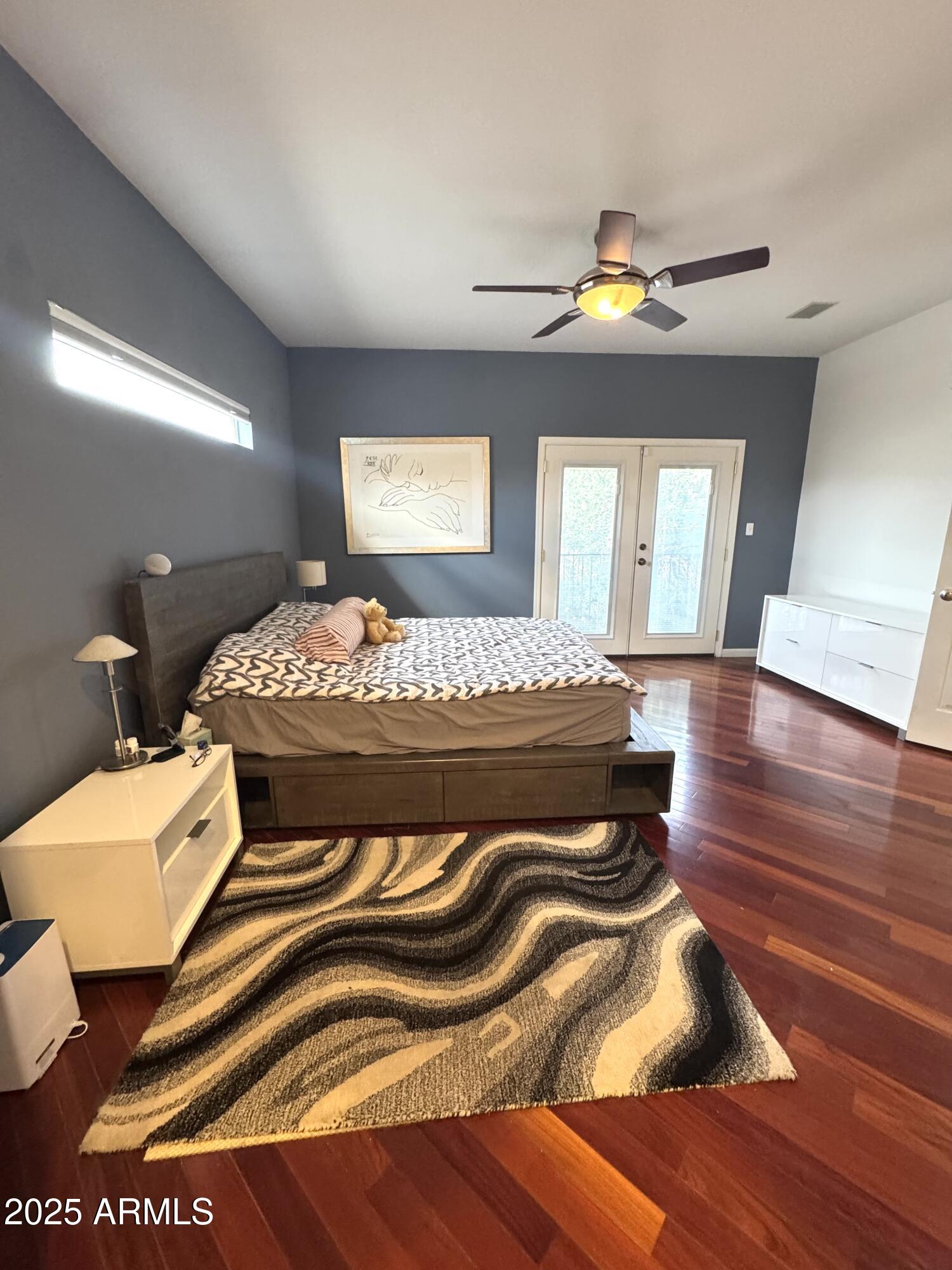 8833 South 51st Street, Unit 3 Phoenix, AZ 85044 - Photo 9 of 26 a bedroom with a bed and wooden floor