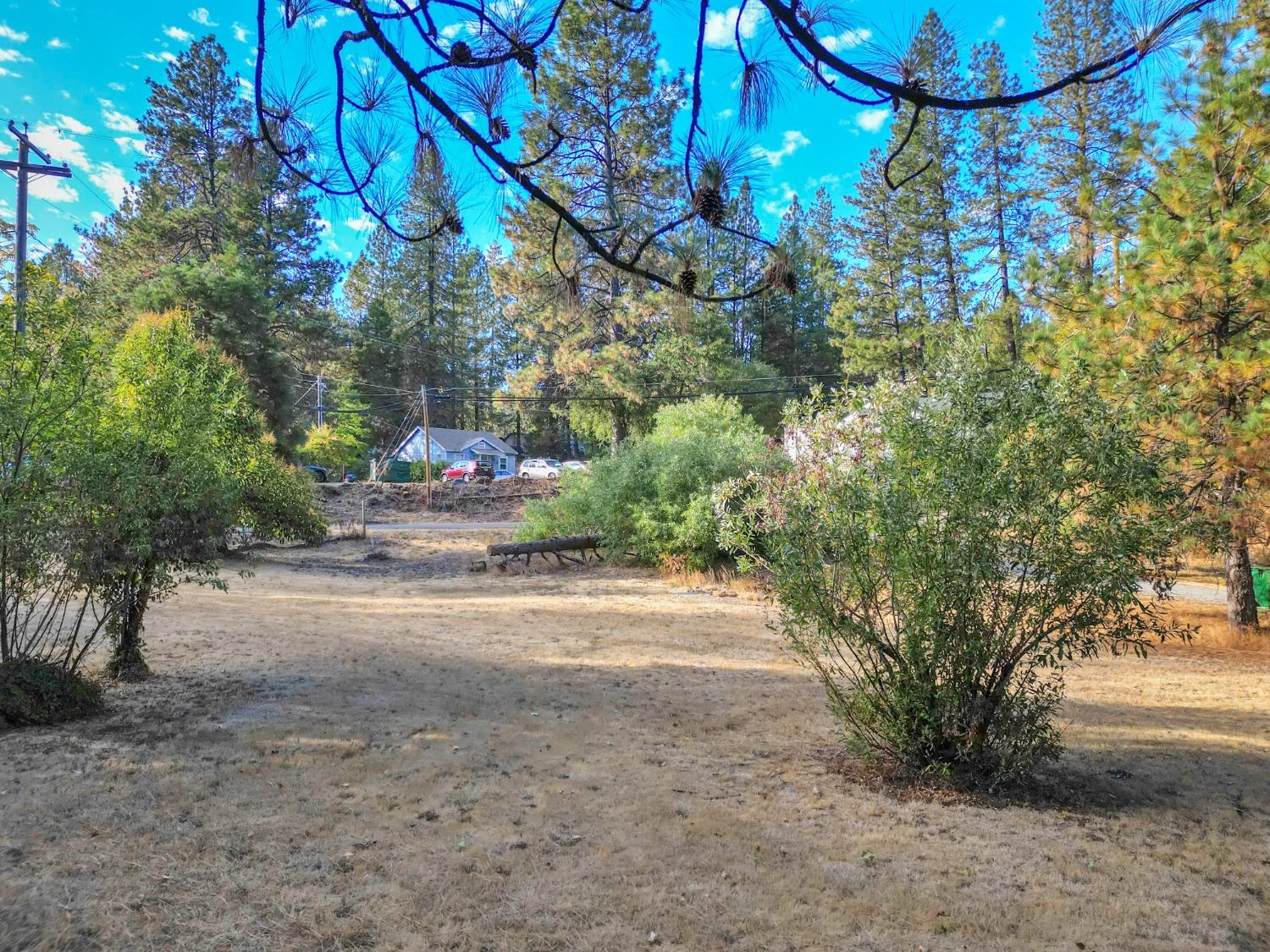 728 Old Washington Road Nevada City, CA 95959 - Photo 4 of 65 a backyard of a house with table and chairs under an umbrella