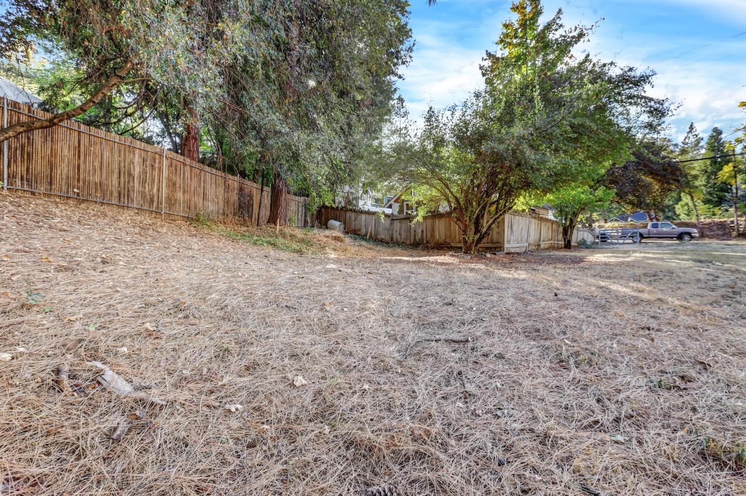 728 Old Washington Road Nevada City, CA 95959 - Photo 48 of 65 a view of a backyard with large trees and wooden fence