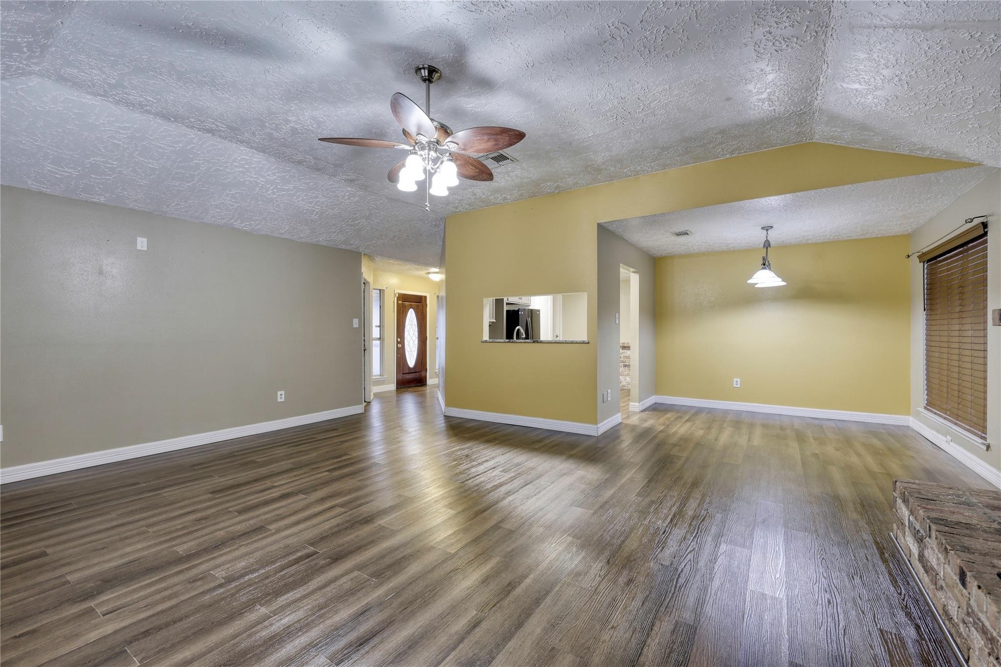 13331 Boyer Lane Houston, TX 77015 - Photo 12 of 21 a view of an empty room with wooden floor and a ceiling fan