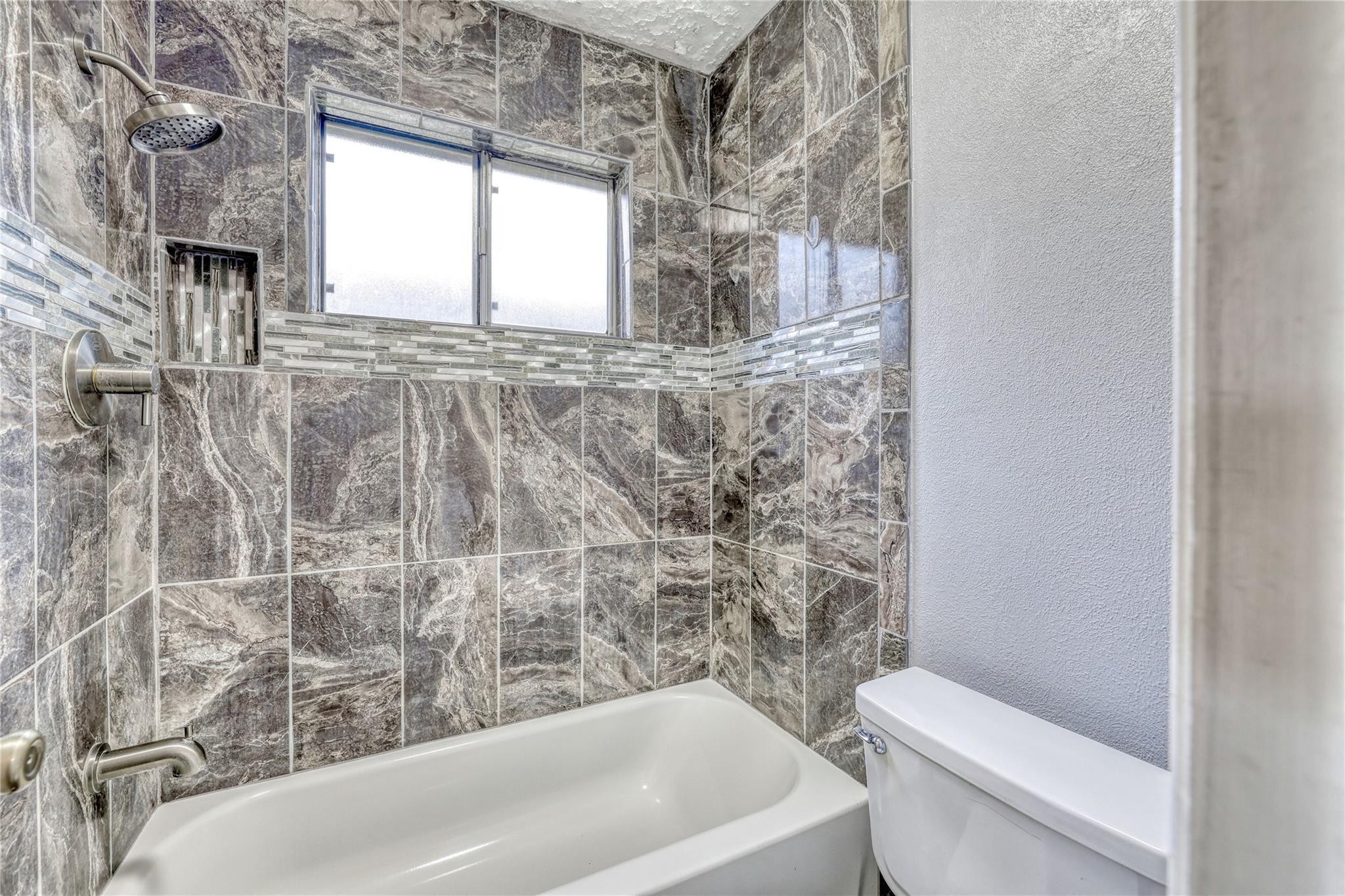 13331 Boyer Lane Houston, TX 77015 - Photo 15 of 21 a bathroom with a toilet and a bathtub
