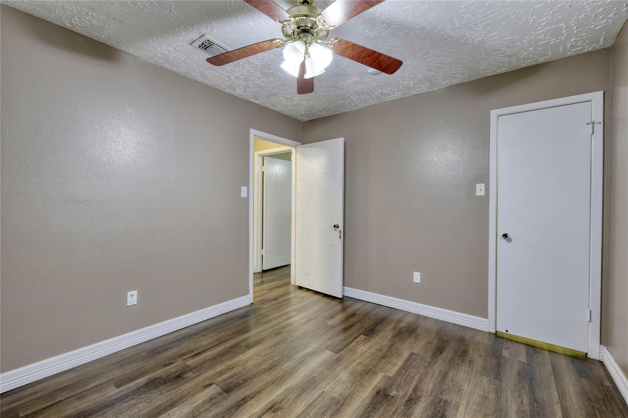 13331 Boyer Lane Houston, TX 77015 - Photo 21 of 21 wooden floor in an empty room with a chandelier fan