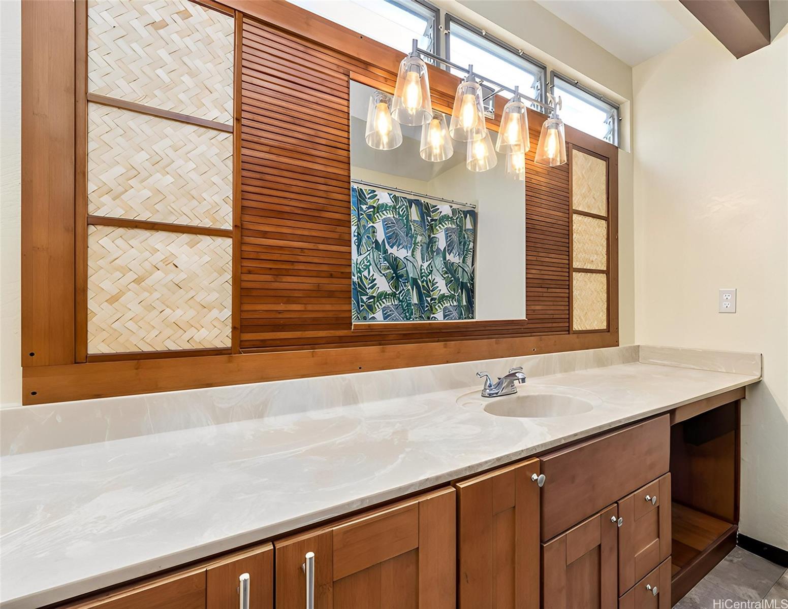 96-214 Waiawa Road, Unit 85 Pearl City, HI 96782 - Photo 7 of 10 a bathroom with a sink and a large mirror