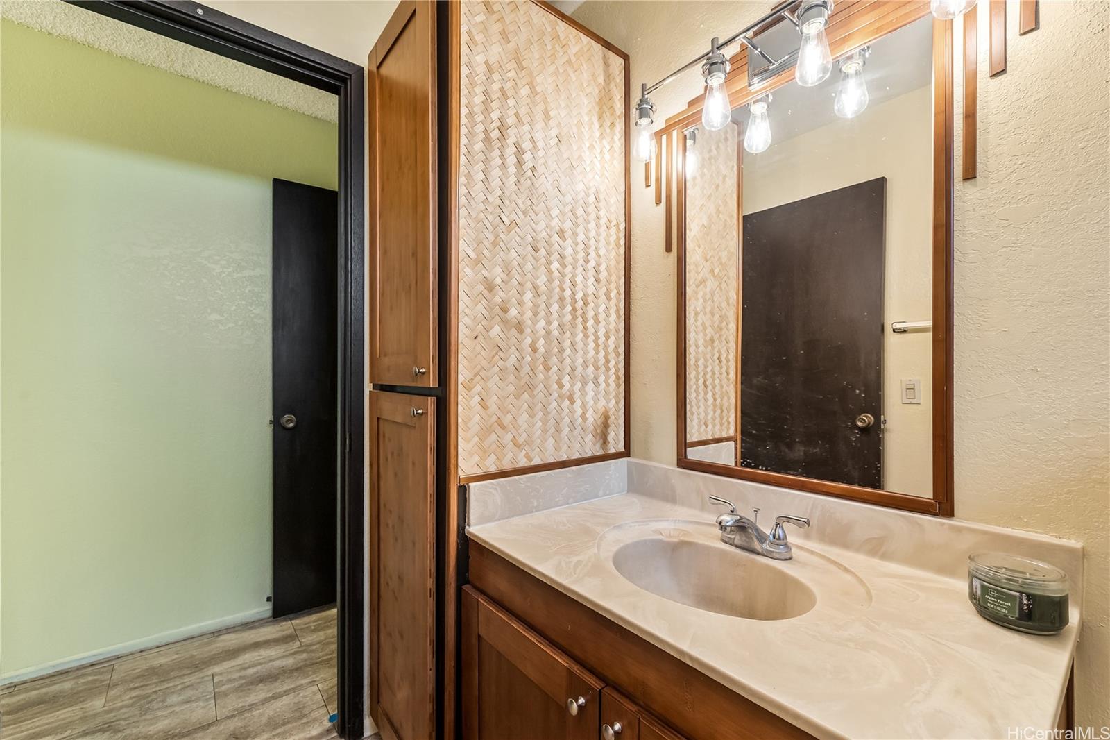 96-214 Waiawa Road, Unit 85 Pearl City, HI 96782 - Photo 9 of 10 a bathroom with a granite countertop sink and a mirror