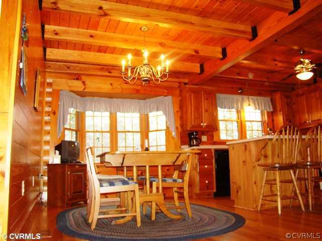 4826 Tatum Road Disputanta, VA 23842 - Photo 11 of 24 a dining room with table chairs and wooden floor