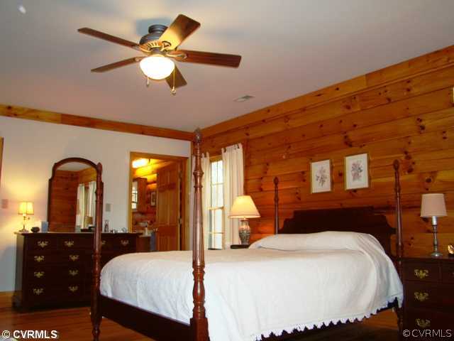 4826 Tatum Road Disputanta, VA 23842 - Photo 15 of 24 a bedroom with a bed and a chandelier