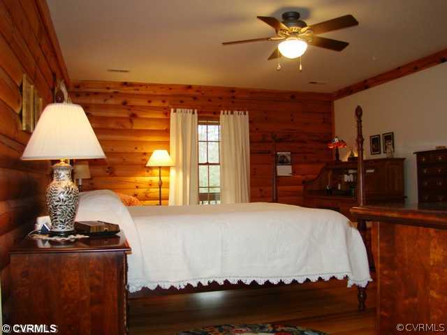 4826 Tatum Road Disputanta, VA 23842 - Photo 16 of 24 a bedroom with a bed and a chandelier