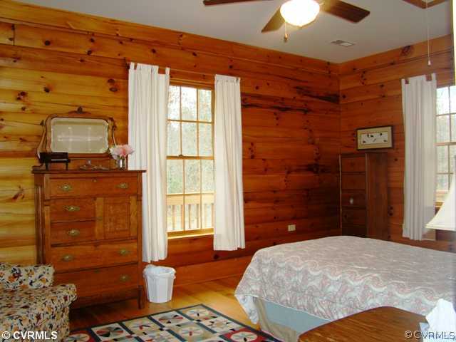4826 Tatum Road Disputanta, VA 23842 - Photo 19 of 24 a bedroom with a bed and a chandelier
