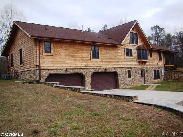 4826 Tatum Road Disputanta, VA 23842 - Photo 23 of 24 a front view of a house with yard and garage