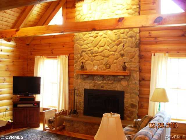 4826 Tatum Road Disputanta, VA 23842 - Photo 5 of 24 a living room with a fireplace furniture a flat screen tv and a fireplace