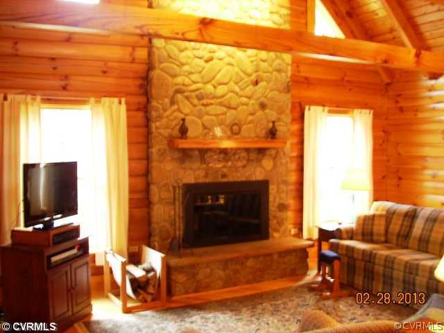 4826 Tatum Road Disputanta, VA 23842 - Photo 6 of 24 a living room with furniture a flat screen tv and a fireplace
