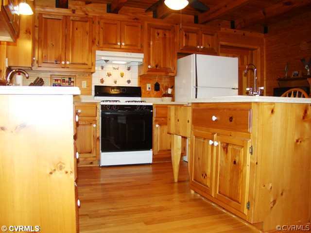 4826 Tatum Road Disputanta, VA 23842 - Photo 9 of 24 a kitchen with stainless steel appliances a refrigerator and a stove