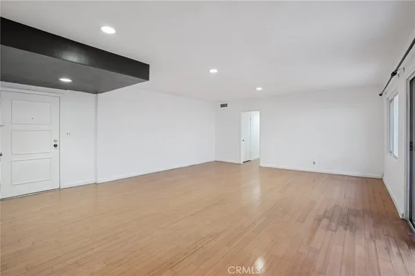 an empty room with wooden floor