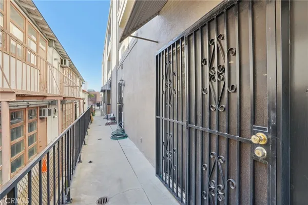 a view of a balcony with wooden fence
