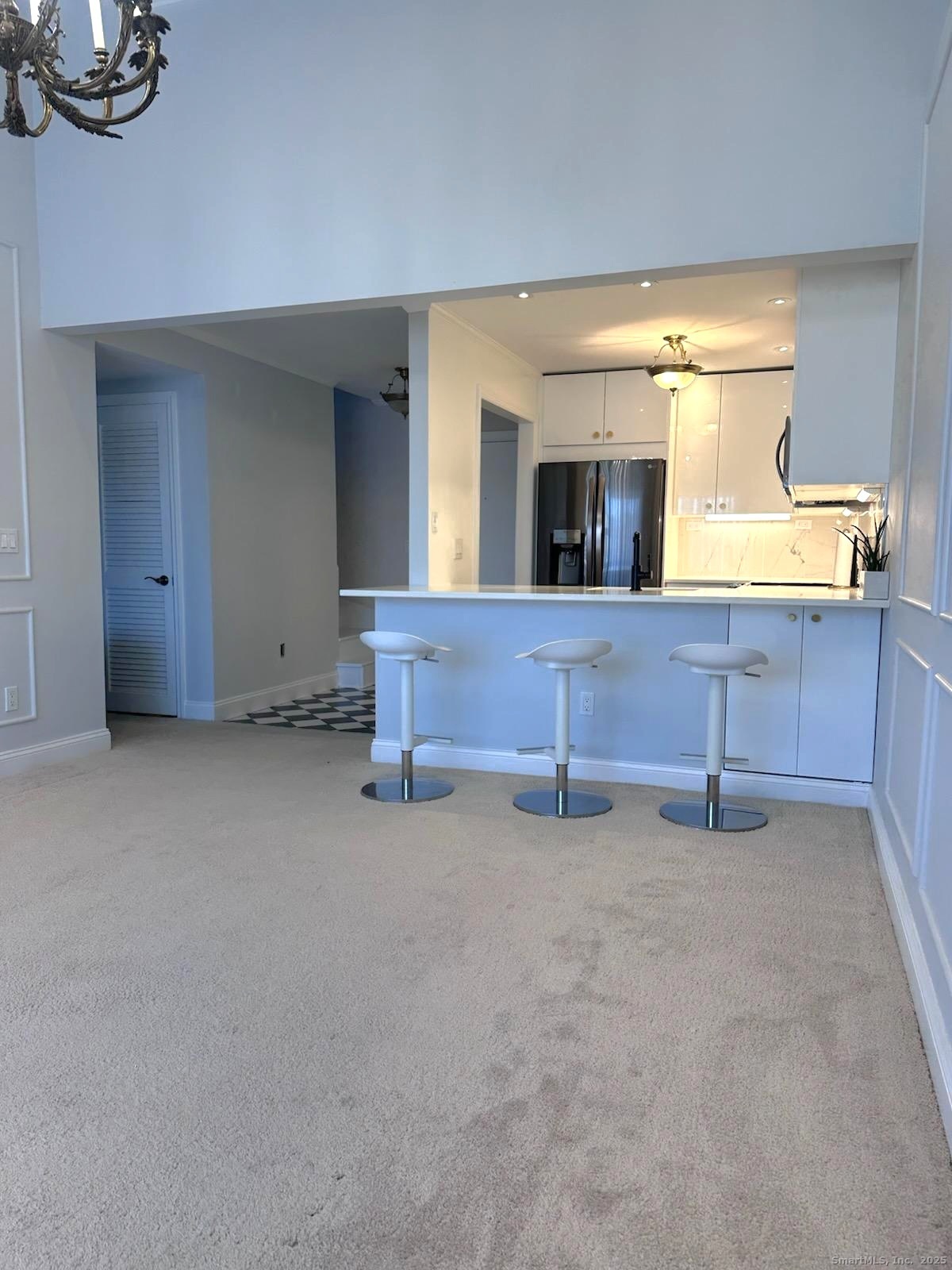 163 South Street, Unit 85 Danbury, CT 06810 - Photo 11 of 18 a view of an empty room with furniture and chandelier