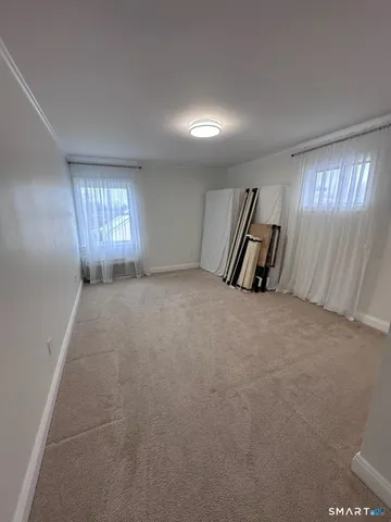 a view of an empty room and a window