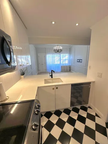 a kitchen with a sink a stove and a microwave