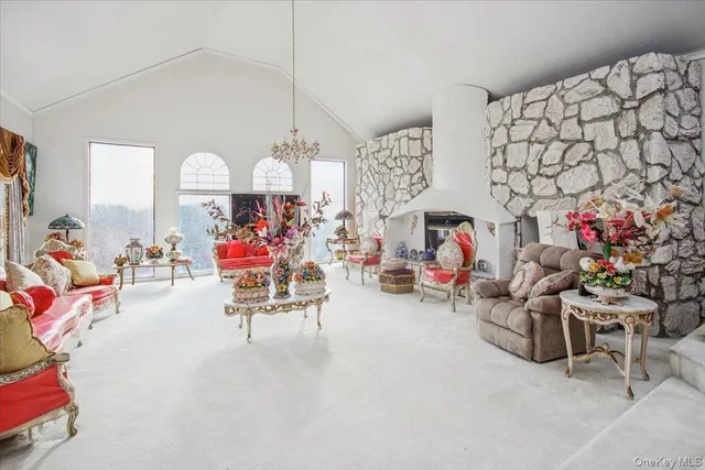 a living room with lots of furniture and a chandelier