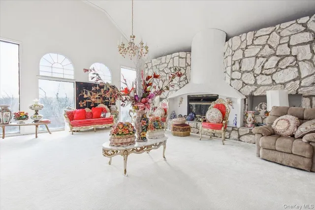 a living room with furniture and a chandelier
