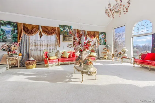 a living room with furniture and a chandelier