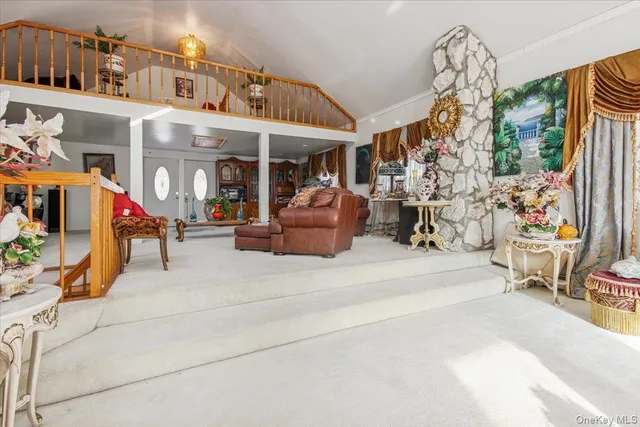 a living room with furniture a fireplace and a chandelier