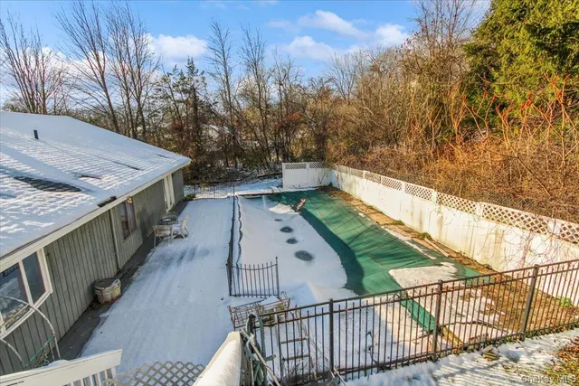 a view of a balcony with wooden floor and fence