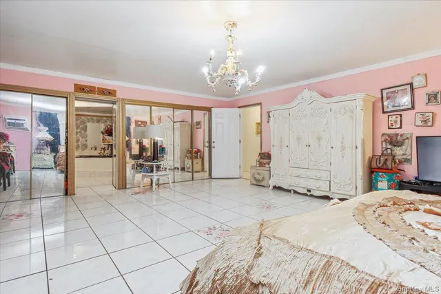 a spacious bedroom with a bed a table and chair