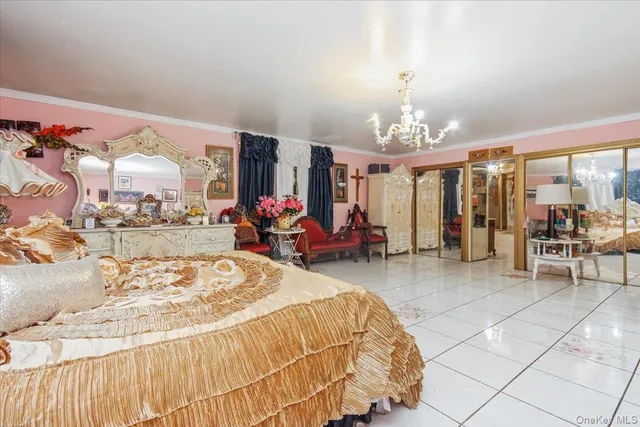 a bed room with a bed and a chandelier