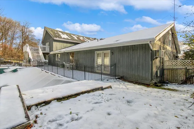 a view of house with backyard and wooden fence