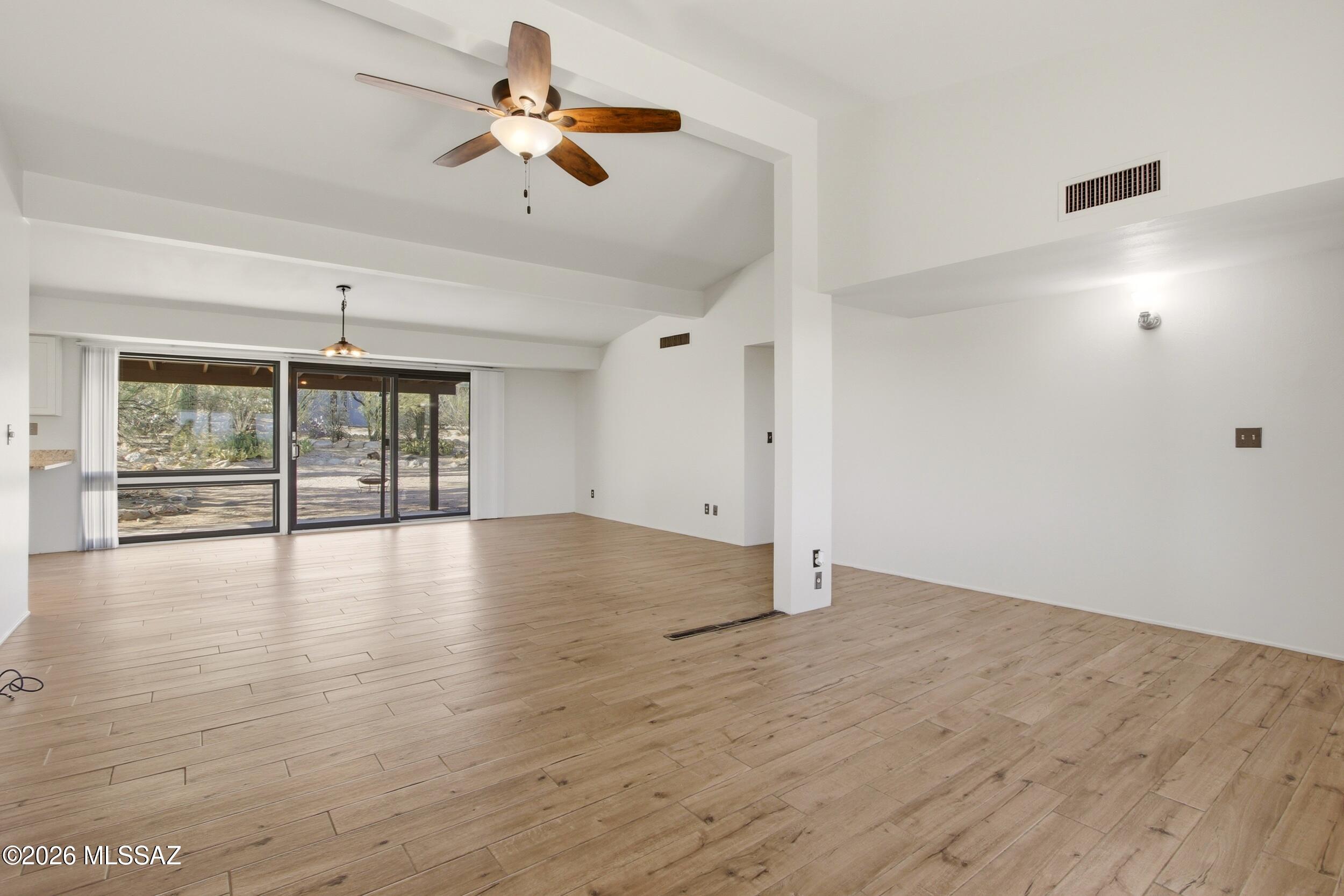 9141 East Indian Canyon Road Tucson, AZ 85749 - Photo 7 of 33 wooden floor in an empty room with a window