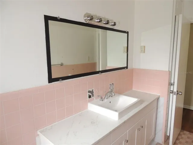 a bathroom with a sink vanity and a mirror