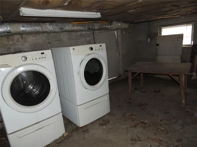 a view of a house with a yard and large tree