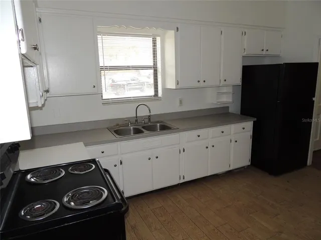 a kitchen with a sink stove and refrigerator