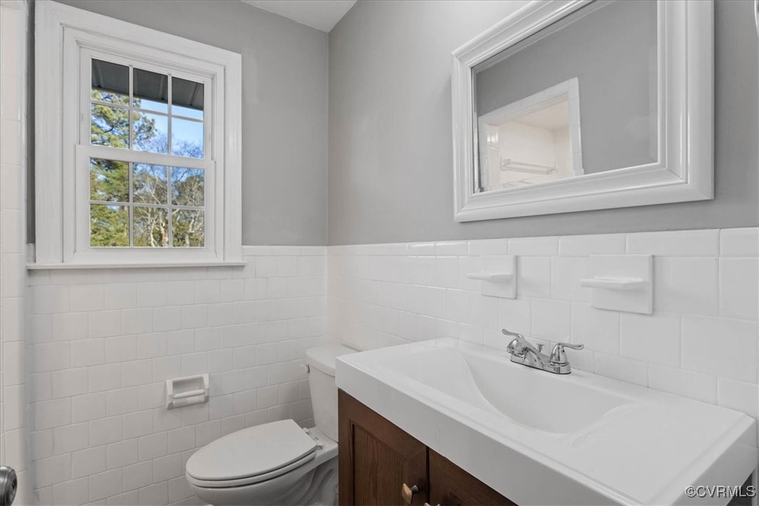 1007 Forestview Drive Colonial Heights, VA 23834 - Photo 26 of 40 Bathroom featuring vanity, tile walls, and toilet