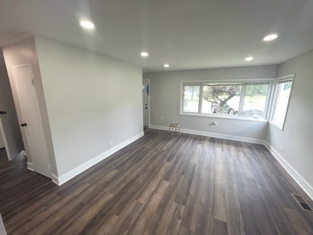 30 Apache Street Park Forest, IL 60466 - Photo 2 of 13 an empty room with wooden floor and windows
