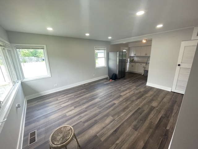 30 Apache Street Park Forest, IL 60466 - Photo 3 of 13 an empty room with wooden floor and windows