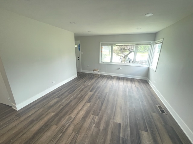 30 Apache Street Park Forest, IL 60466 - Photo 6 of 13 an empty room with wooden floor and windows
