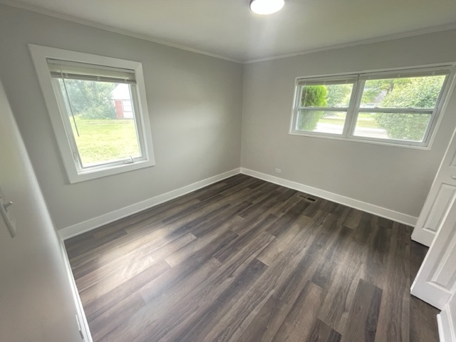 30 Apache Street Park Forest, IL 60466 - Photo 7 of 13 a view of an empty room with wooden floor and a window