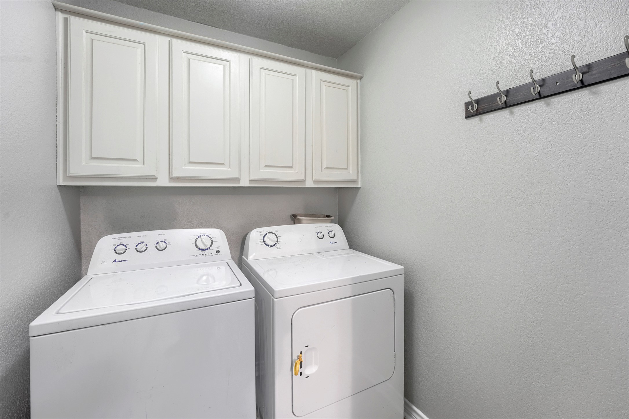 1105 2nd Street Jarrell, TX 76537 - Photo 21 of 27 Functional laundry space featuring convenient upper cabinetry for storage.
