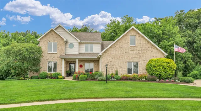 a view of a house with garden and yard
