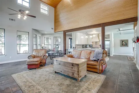 a kitchen with kitchen island granite countertop a table and chairs in it