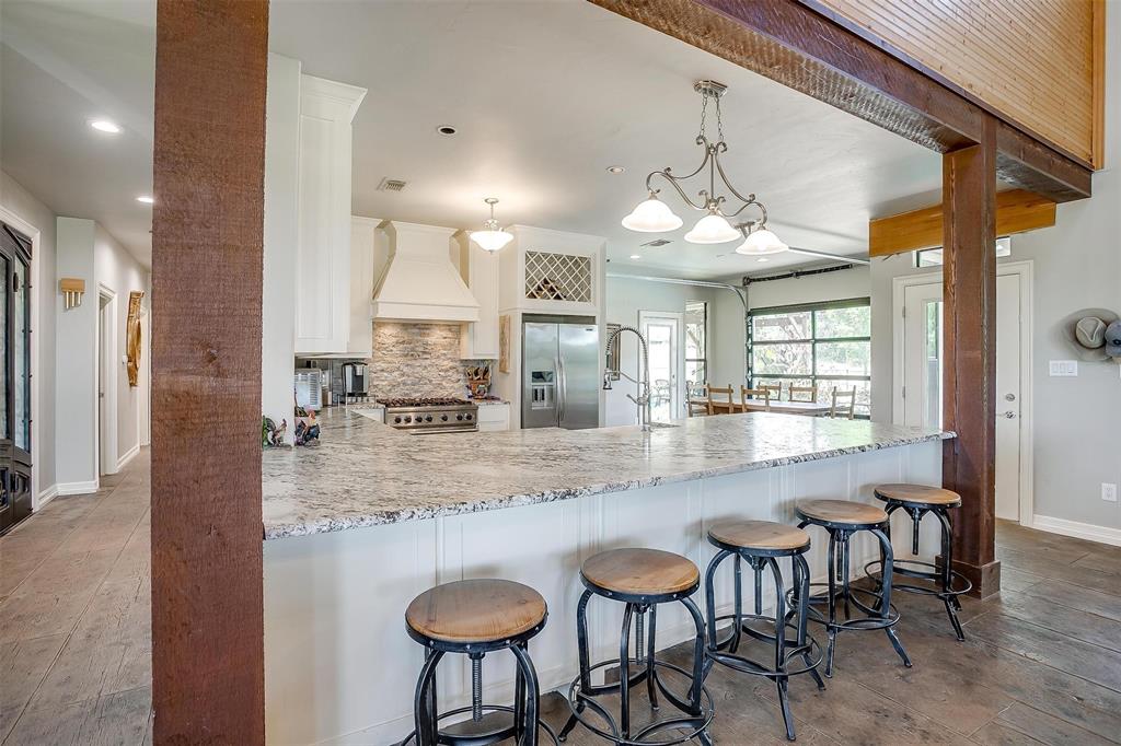 819 Old Annetta Road Aledo, TX 76008 - Photo 16 of 39 a kitchen with kitchen island granite countertop a table and chairs in it